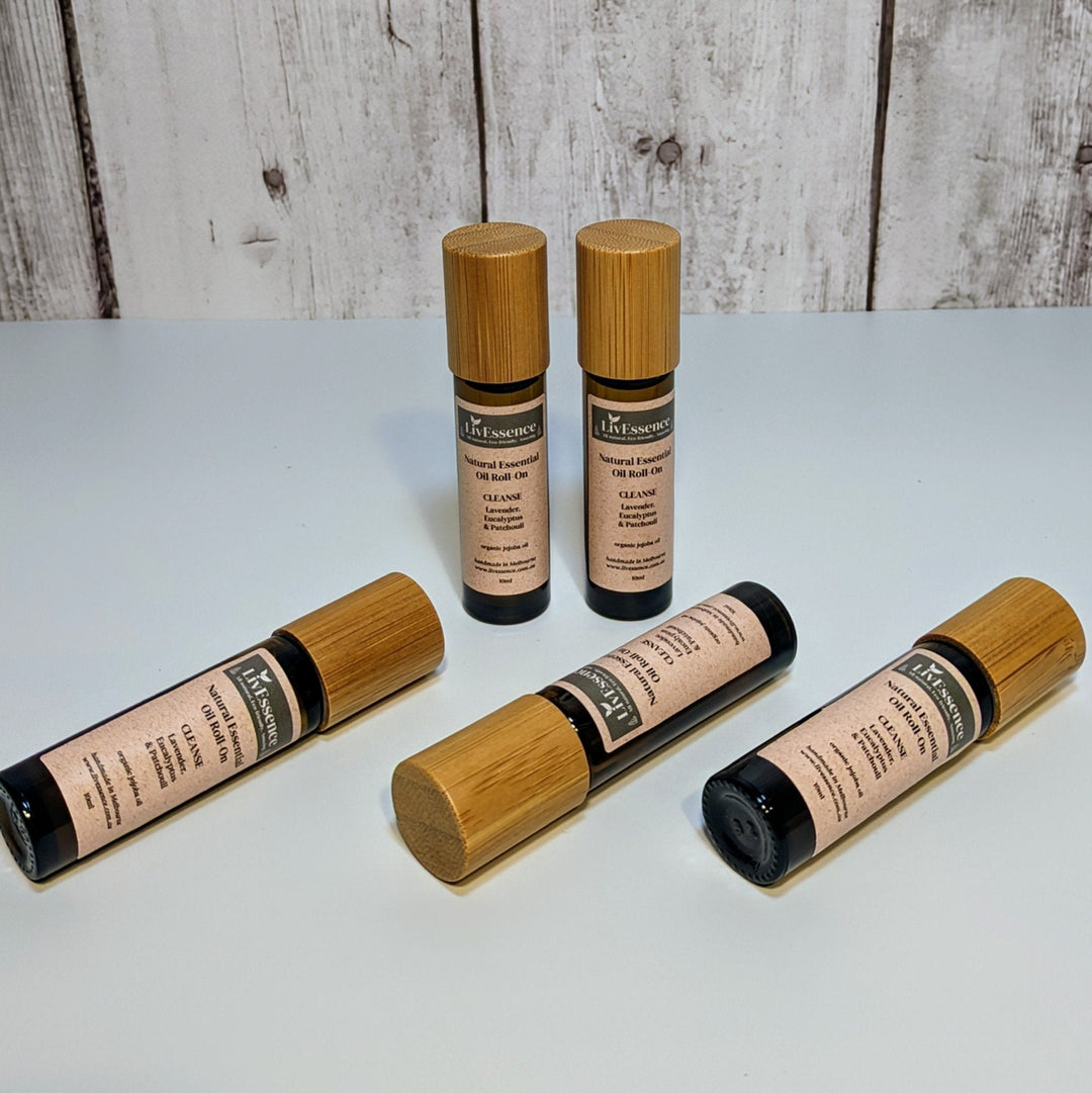 a photo of amber glass roll-on vessels with bamboo lid, smooth metal rollerball