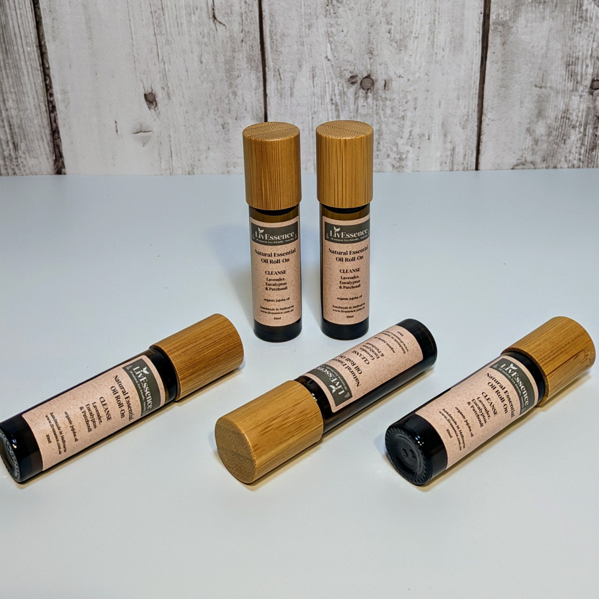 a photo of amber glass roll-on vessels with bamboo lid, smooth metal rollerball